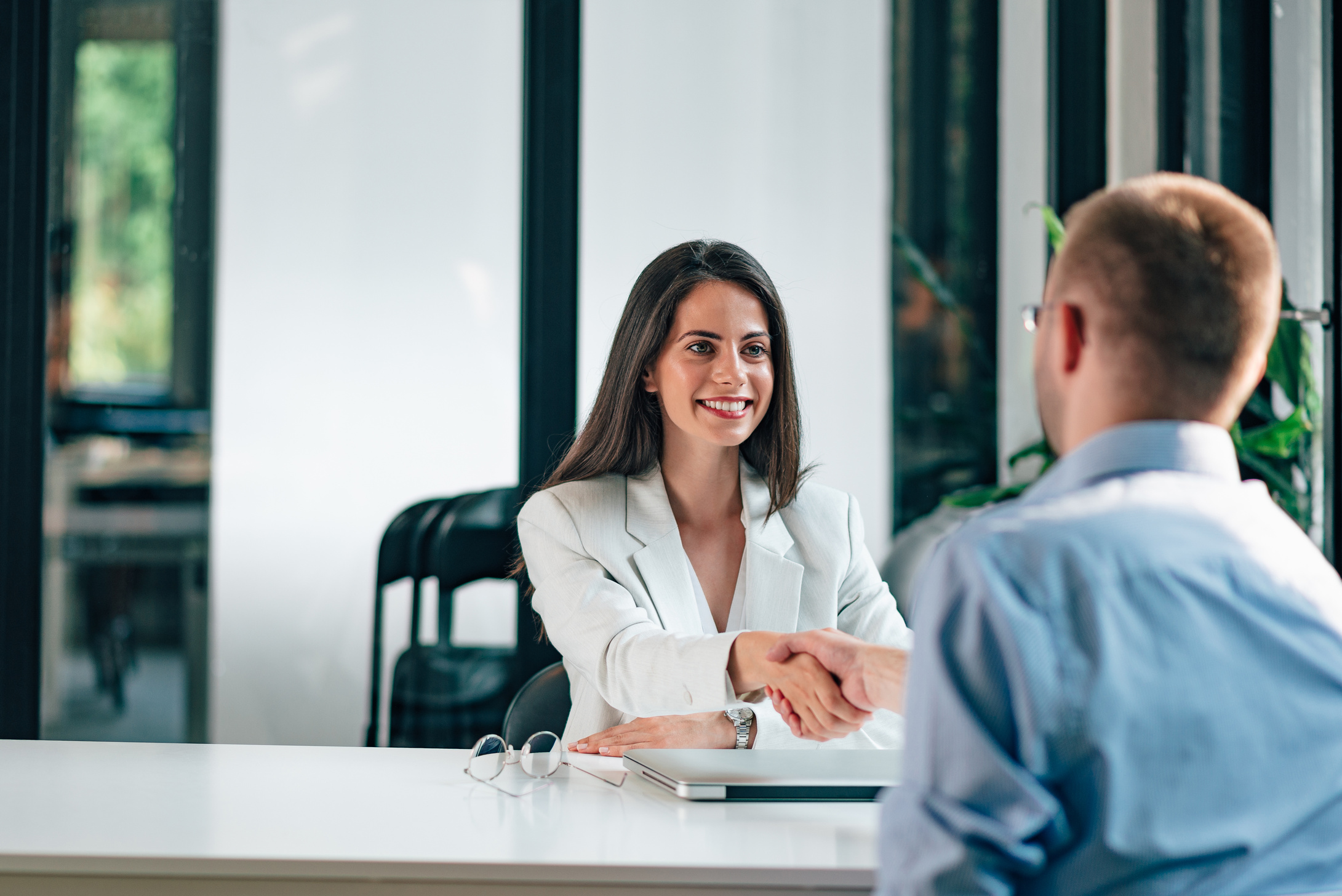 Female hr manager greeting job candidate.